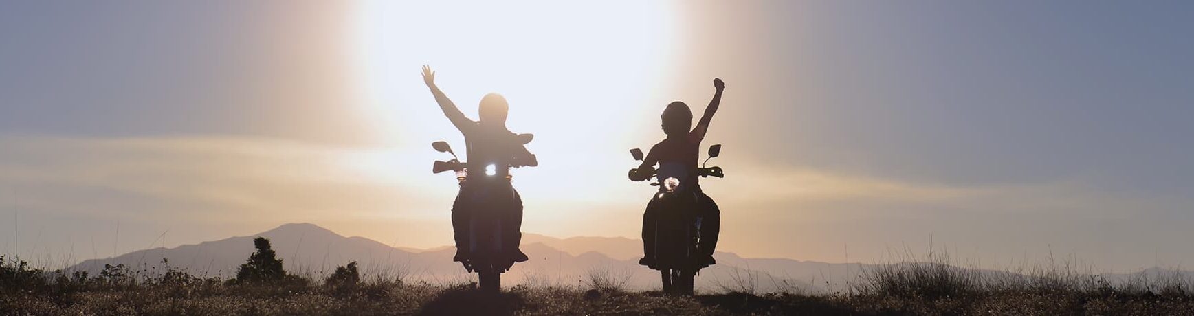 two people with arms raised in victory